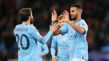 MANCHESTER, ENGLAND - OCTOBER 05: Riyad Mahrez  celebrates with Bernardo Silva of Manchester City after scoring their team's fourth goal from the penalty spot during the UEFA Champions League group G match between Manchester City and FC Copenhagen at Etihad Stadium on October 05, 2022 in Manchester, England. (Photo by Matt McNulty - Manchester City/Manchester City FC via Getty Images)