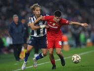 Monterrey's Spanish midfielder #10 Sergio Canales and Toluca's Argentine forward #05 Franco Romero fight for the ball during the first leg of the Liga MX Apertura semifinal football match between Monterrey and Toluca at BBVA Stadium in Monterrey, Nuevo Leon state, Mexico, on December 3, 2025. (Photo by Julio Cesar AGUILAR / AFP)