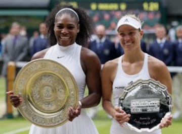 Serena Williams of the U.S, left, holds up her trophy next to Angelique Kerber of Germany after beating her in the women's singles final on day thirteen of the Wimbledon Tennis Championships in London, Saturday, July 9, 2016.