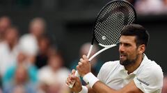 Serbia's Novak Djokovic returns the ball to Italy's Jannik Sinner during their men's singles semi-finals tennis match on the twelfth day of the 2023 Wimbledon Championships at The All England Lawn Tennis Club in Wimbledon, southwest London, on July 14, 2023. (Photo by Adrian DENNIS / AFP) / RESTRICTED TO EDITORIAL USE