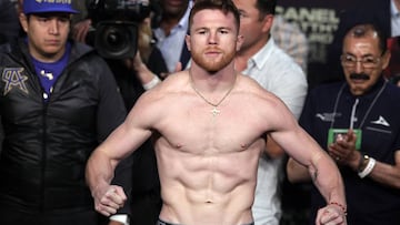 (FILES) In this file photo taken on May 05, 2017 Boxer Saul "Canelo" Alvarez poses on the scales during his weigh-in with Julio Cesar Chavez, Jr. at the MGM Grand Arena in Las Vegas, Nevada. - Saul "Canelo" Alvarez bids to extend his dominance of the middleweight division here May 4, 2019, when he takes on Daniel Jacobs in an eagerly anticipated unification bout. Mexican icon Alvarez is putting his World Boxing Association and World Boxing Council titles on the line when he faces Jacobs at the T-Mobile Arena aiming to claim the American's International Boxing Federation belt. (Photo by JOHN GURZINSKI / AFP)