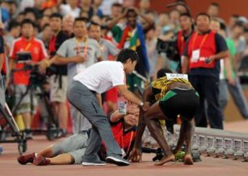 Un cámara de televisión en su 'Segway' se llevó por delante a Usain Bolt en la vuelta de honor de la final de 200m.