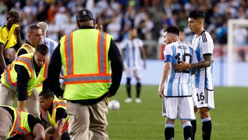Argentina's Lionel Messi (2nd R) reacts as a fan who ran onto the pitch to ask for an autograph is tackled by security during the international friendly football match between Argentina and Jamaica at Red Bull Arena in Harrison, New Jersey, on September 27, 2022. (Photo by Andres Kudacki / AFP)
