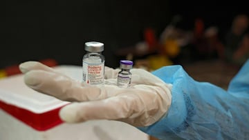 A Palestinian Ministry of Health employee prepares a dose of vaccine during a Pfizer-BioNTech and Moderna vaccine drive in the village of Dura, west of Hebron, in the Israeli-occupied West Bank on December 27, 2021.