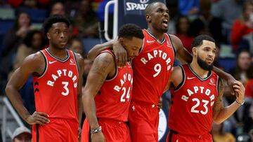 Nov 8, 2019; New Orleans, LA, USA; Toronto Raptors forward Serge Ibaka (9) is helped off the court by guards Norman Powell (24) and Fred VanVleet (23) in the second quarter against the New Orleans Pelicans at the Smoothie King Center. Mandatory Credit: Chuck Cook-USA TODAY Sports