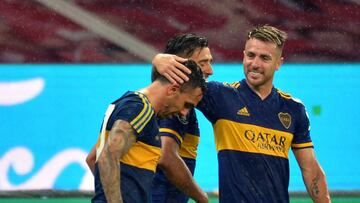 PORTO ALEGRE, BRAZIL - DECEMBER 02: Carlos Tevez of Boca Juniors celebrates with teammates after scoring the first goal of his team wearing a vintage jersey of Boca Juniors in tribute to the late football legend Diego Maradona during a round of sixteen first leg match between Internacional and Boca Juniors as part of Copa Conmebol Libertadores 2020 at Beira-Rio Stadium on December 02, 2020 in Porto Alegre, Brazil. (Photo by Silvio Avila-Pool/Getty Images)