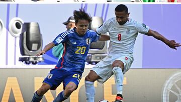 Iran's midfielder #08 Omid Ebrahimi fights for the ball with Japan's midfielder #20 Takefusa Kubo during the Qatar 2023 AFC Asian Cup quarter-final football match between Iran and Japan at Education City Stadium in al-Rayyan, west of Doha, on February 3, 2024. (Photo by HECTOR RETAMAL / AFP)