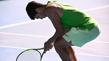 Spain's Carlos Alcaraz stretches after a point against Germany's Alexander Zverev during their men's singles semi-final match on day thirteen of the Australian Open tennis tournament in Melbourne on January 30, 2026. (Photo by WILLIAM WEST / AFP) / -- IMAGE RESTRICTED TO EDITORIAL USE - STRICTLY NO COMMERCIAL USE --
