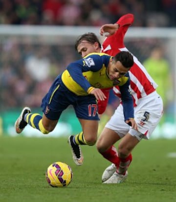 STOKE ON TRENT, ENGLAND - DECEMBER 06:  Alexis Sanchez of Arsenal is brought down by Marc Muniesa of Stoke City during the Barclays Premier League match between Stoke City and Arsenal  at the Britannia Stadium on December 6, 2014 in Stoke on Trent, England.  (Photo by Clive Mason/Getty Images)