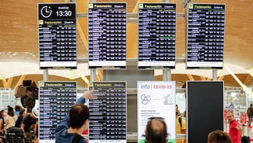 MADRID, SPAIN - JULY 01: Passengers look at the flight displays at Terminal 4 of Adolfo Suarez Madrid Barajas Airport, on July 1, 2022, in Madrid, Spain. As every year, the start of the summer months means an increase in airport travel. This July 1, 2022 is marked by strikes at several international airlines. Specifically, tourists who choose destinations abroad will be affected by the strike of Ryanair workers, which began on June 24 and will last until tomorrow, July 2. This is in addition to the Easyjet strike, which began today with the cancellation of 7 flights and delays in 12 others. (Photo By Carlos Lujan/Europa Press via Getty Images)