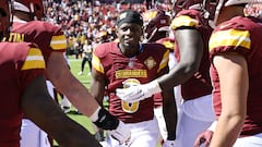 LANDOVER, MARYLAND - OCTOBER 09: Brian Robinson #8 of the Washington Commanders reacts with teammates during pregame against the Tennessee Titans at FedExField on October 09, 2022 in Landover, Maryland.   Greg Fiume/Getty Images/AFP