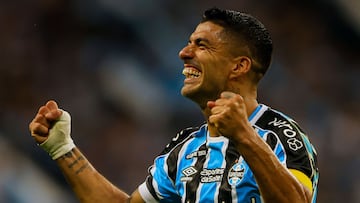 (FILES) Gremio's Uruguayan forward Luis Suarez celebrates after scoring a goal -then disallowed following a VAR check- during the Brazilian Championship football match between Gremio and Vasco da Gama at the Arena do Gremio stadium in Porto Alegre, Brazil, on December 3, 2023. Uruguay's Luis Suarez will be reunited with his friend Lionel Messi for the 2024 MLS season after Inter Miami officially announced it had signed the 36-year-old attacker on December 22. (Photo by SILVIO AVILA / AFP)