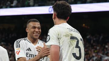 Real Madrid's Spanish defender #31 Jacobo Ramon (R) is congratulated by teammate Real Madrid's French forward #09 Kylian Mbappe after scoring their second goal during the Spanish league football match between Real Madrid CF and RCD Mallorca at the Santiago Bernabeu Stadium in Madrid, on May 14, 2025. (Photo by Pierre-Philippe MARCOU / AFP)