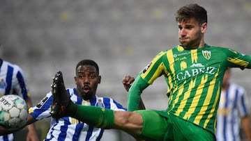 Tondela's Spanish forward Mario Gonzalez (R) vies with FC Porto's Portuguese midfielder Wilson Manafa during the Portuguese League football match between CD Tondela and FC Porto at the Joao Cardoso stadium in Tondela on April 10, 2021. (Photo b