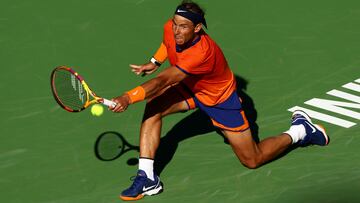 INDIAN WELLS, CALIFORNIA - MARCH 12: Rafael Nadal of Spain plays a backhand against Sebastian Korda of the United States in their second round match on Day 6 of the BNP Paribas Open at the Indian Wells Tennis Garden on March 12, 2022 in Indian Wells, California.   Clive Brunskill/Getty Images/AFP
== FOR NEWSPAPERS, INTERNET, TELCOS & TELEVISION USE ONLY ==