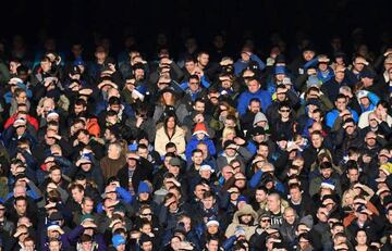 Fans shield their eyes from the sunshine during the English Premier League football match between Everton and Chelsea at Goodison Park in Liverpool, north west England on December 23, 2017.
