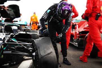El británico observa la rueda pinchada de su monoplaza que no impidió su victoria en Silverstone.