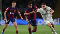 Barcelona's Spanish forward #27 Lamine Yamal vies with Shakhtar Donetsk's Ukrainian defender #22 Mykola Matviyenko (R) during the UEFA Champions League 1st round Group H football match between FC Barcelona and Shakhtar Donetsk at the Estadi Olimpic Lluis Companys in Barcelona on October 25, 2023. (Photo by LLUIS GENE / AFP)