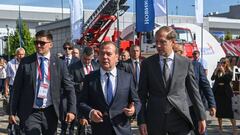 Russia's Minister of Industry and Trade Denis Manturov (R) and Deputy Chairman of the Russian Security Council Dmitry Medvedev (C) visit the Army-2022 International Military-Technical Forum at the Russian Armed Forces' Patriot Park in Kubinka, outside Moscow, on August 16, 2022. (Photo by NATALIA KOLESNIKOVA / AFP) (Photo by NATALIA KOLESNIKOVA/AFP via Getty Images)