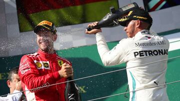 Formula One F1 - Hungarian Grand Prix - Hungaroring, Budapest, Hungary - July 29, 2018 Mercedesâ Lewis Hamilton celebrates on the podium after winning the race alongside second placed Ferrariâs Sebastian Vettel REUTERS/Lisi Niesner