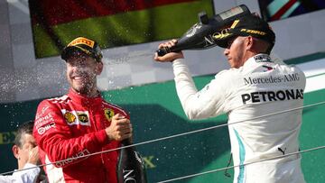 Formula One F1 - Hungarian Grand Prix - Hungaroring, Budapest, Hungary - July 29, 2018   Mercedes&acirc; Lewis Hamilton celebrates on the podium after winning the race alongside second placed Ferrari&acirc;s Sebastian Vettel    REUTERS/Lisi Niesner