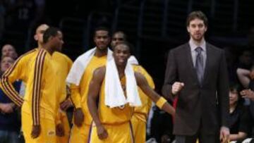 Los Angeles Lakers Pau Gasol of Spain (R) celebrates from the bench during their NBA basketball overtime win against the Toronto Raptors in Los Angeles March 8, 2013. REUTERS/Lucy Nicholson (UNITED STATES - Tags: SPORT BASKETBALL)