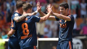 Valencia's Portuguese forward Goncalo Guedes (R) celebrates a goal with Valencia's Spanish forward Santi Mina and Valencia's Argentinian forward Luciano Vietto (C) during the Spanish league football match between Valencia CF and RC Deportiv