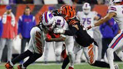 CINCINNATI, OHIO - JANUARY 02: James Cook #28 of the Buffalo Bills is tackled by Jessie Bates III #30 and Cam Taylor-Britt #29 of the Cincinnati Bengals during the first quarter at Paycor Stadium on January 02, 2023 in Cincinnati, Ohio.   Kirk Irwin/Getty Images/AFP (Photo by Kirk Irwin / GETTY IMAGES NORTH AMERICA / Getty Images via AFP)