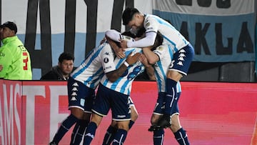 Racing's midfielder Axel Ojeda (Covered) celebrates with teammates after scoring a goal during the Copa Libertadores round of 16 second leg football match between Argentina's Racing Club and Colombia's Atletico Nacional, at the Presidente Juan Domingo Peron (El Cilindro) stadium, in Buenos Aires, on August 10, 2023. (Photo by Luis ROBAYO / AFP)