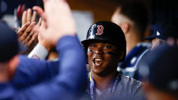 ST PETERSBURG, FLORIDA - MAY 20: Rafael Devers #11 of the Boston Red Sox reacts with teammates after hitting a two run home run during the third inning against the Tampa Bay Rays continuing his home run streak to six games in a row at Tropicana Field on May 20, 2024 in St Petersburg, Florida. Douglas P. DeFelice/Getty Images/AFP (Photo by Douglas P. DeFelice / GETTY IMAGES NORTH AMERICA / Getty Images via AFP)