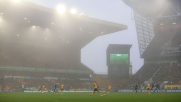 Wolverhampton Wanderers&#039; English defender Conor Coady controls the ball in the fog during the English Premier League football match between Wolverhampton Wanderers and Chelsea at the Molineux stadium in Wolverhampton, central England on December 19, 2021. (Photo by Lindsey Parnaby / AFP) / RESTRICTED TO EDITORIAL USE. No use with unauthorized audio, video, data, fixture lists, club/league logos or &#039;live&#039; services. Online in-match use limited to 120 images. An additional 40 images may be used in extra time. No video emulation. Social media in-match use limited to 120 images. An additional 40 images may be used in extra time. No use in betting publications, games or single club/league/player publications. / 