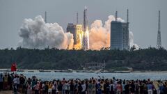 (FILES) In this file photo taken on April 29, 2021 People watch a Long March 5B rocket, carrying China&#039;s Tianhe space station core module, as it lifts off from the Wenchang Space Launch Center in southern China&#039;s Hainan province. - The Pentagon 