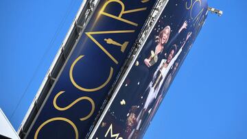 A sign announcing the upcoming Oscars Award show towers over Hollywood Boulevard, March 18, 2022, in Hollywood, California. - The 94th Academy Awards will take place on March 27, 2022 at the Dolby Theatre. (Photo by Robyn Beck / AFP)