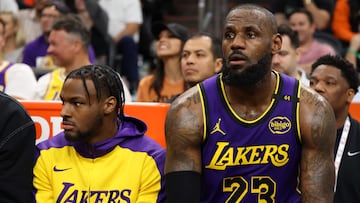 PHOENIX, ARIZONA - OCTOBER 28: Bronny James #9 and LeBron James #23 of the Los Angeles Lakers look on during the second half against the Phoenix Suns at Footprint Center on October 28, 2024 in Phoenix, Arizona. NOTE TO USER: User expressly acknowledges and agrees that, by downloading and or using this photograph, User is consenting to the terms and conditions of the Getty Images License Agreement. Christian Petersen/Getty Images/AFP (Photo by Christian Petersen / GETTY IMAGES NORTH AMERICA / Getty Images via AFP)