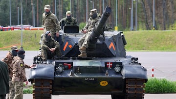 Soldiers sit on a tank at a training site where Ukrainian soldiers undergo maintenance training on Leopard 1A5 tanks, at the German army Bundeswehr base, part of the EU Military Assistance Mission in support of Ukraine (EUMAM Ukraine), on the day of German Defence Minister Boris Pistorius and Danish acting Defence Minister Troels Lund Poulsen's visit, in Klietz, Germany, May 5, 2023. REUTERS/Fabrizio Bensch