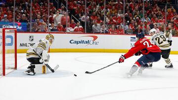Washington Capitals center Connor McMichael (24) attempts to deflect the puck on Boston Bruins goaltender Jeremy Swayman (1).
