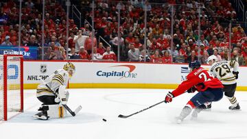 Washington Capitals center Connor McMichael (24) attempts to deflect the puck on Boston Bruins goaltender Jeremy Swayman (1).