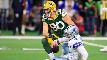 ARLINGTON, TEXAS - JANUARY 14: Dak Prescott #4 of the Dallas Cowboys is sacked by Lukas Van Ness #90 of the Green Bay Packers during the second half of the NFC Wild Card Playoff game at AT&T Stadium on January 14, 2024 in Arlington, Texas.   Ron Jenkins/Getty Images/AFP (Photo by Ron Jenkins / GETTY IMAGES NORTH AMERICA / Getty Images via AFP)