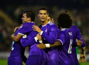 Real Madrid's Portuguese forward Cristiano Ronaldo (C) and Real Madrid's Portuguese defender Pepe (L) congratulates Real Madrid's midfielder Isco (hidden) after he scored during the Spanish league football match Real Betis vs Real Madrid CF at the Benito 