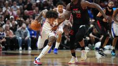 Apr 4, 2024; Miami, Florida, USA;  Philadelphia 76ers guard Kelly Oubre Jr. (9) picks up a loose ball and drives past Miami Heat forward Jimmy Butler (22) during the second half at Kaseya Center. Mandatory Credit: Jim Rassol-USA TODAY Sports