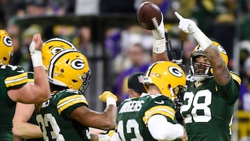 GREEN BAY, WISCONSIN - JANUARY 01: AJ Dillon #28 of the Green Bay Packers celebrates with teammates after scoring a touchdown during the fourth quarter against the Minnesota Vikings at Lambeau Field on January 01, 2023 in Green Bay, Wisconsin.   Kayla Wolf/Getty Images/AFP (Photo by Kayla Wolf / GETTY IMAGES NORTH AMERICA / Getty Images via AFP)