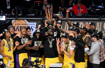 Los Angeles Lakers forward LeBron James (23) hoists the NBA Cup and celebrates 