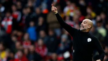 Manchester City's Spanish manager Pep Guardiola shouts instructions to his players from the touchline during the English Premier League football match between Arsenal and Manchester City at the Emirates Stadium in London on January 1, 2022. (Photo by