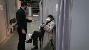 PARIS, FRANCE - FEBRUARY 11: A health worker (left) consults with a man that just got his COVID-19 vaccination jab on February 11, 2021 at a public cultural centre turned into a vaccination venue in Paris, France. The European Union has pushed forward its COVID-19 vaccination target date by three months, the president of the European Commission announced this week. The bloc now aims to vaccinate 70% of the adult population by the end of the summer, Ursula von der Leyen said at the European Parliament. (Photo by Siegfried Modola/Getty Images)