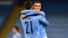 Manchester City&#039;s English midfielder Phil Foden (R) embraces Manchester City&#039;s Spanish midfielder Ferran Torres (L) on the pitch after the UEFA Champions League football Group C match between Manchester City and Porto at the Etihad Stadium in Ma