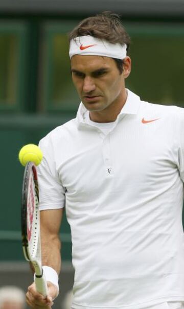 El suizo Roger Federer, rebota la pelota en el borde de su raqueta durante el partido de tenis individual masculino contra Victor Hanescu de Rumania en el Campeonato de Wimbledon