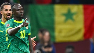 Senegal's forward #10 Sadio Mane celebrates his goal with Senegal's forward #13 Iliman Ndiaye during the Africa Cup of Nations (CAN) semi-final football match between Senegal and Egypt at the Grand stadium in Tangiers on January 14, 2026. (Photo by SEBASTIEN BOZON / AFP)