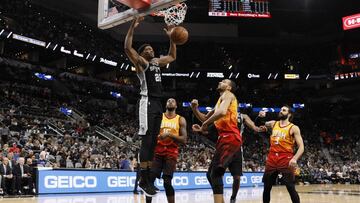 Dec 9, 2018; San Antonio, TX, USA; San Antonio Spurs small forward Rudy Gay (22) dunk the ball in front of Utah Jazz center Rudy Gobert (27), Derrick Favors (15), and Ricky Rubio (3) during the second half at AT&T Center. Mandatory Credit: Soobum Im-USA TODAY Sports