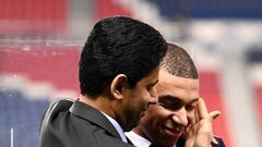 Paris Saint-Germain&#039;s Qatari president Nasser Al-Khelaifi (L) speaks and interacts with Paris-Saint-Germain&#039;s French forward Kylian Mbappe (R) after a press conference to annonce new shirt sponsorship deal between the PSG and the French multinat