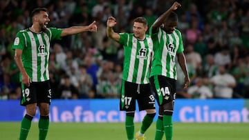 Real Betis' Portuguese midfielder William Carvalho (R) celebrates with teammates after scoring his team's third goal during the Spanish League football match between Real Betis and UD Almeria at the Benito Villamarin stadium in Seville on October 16, 2022. (Photo by CRISTINA QUICLER / AFP)